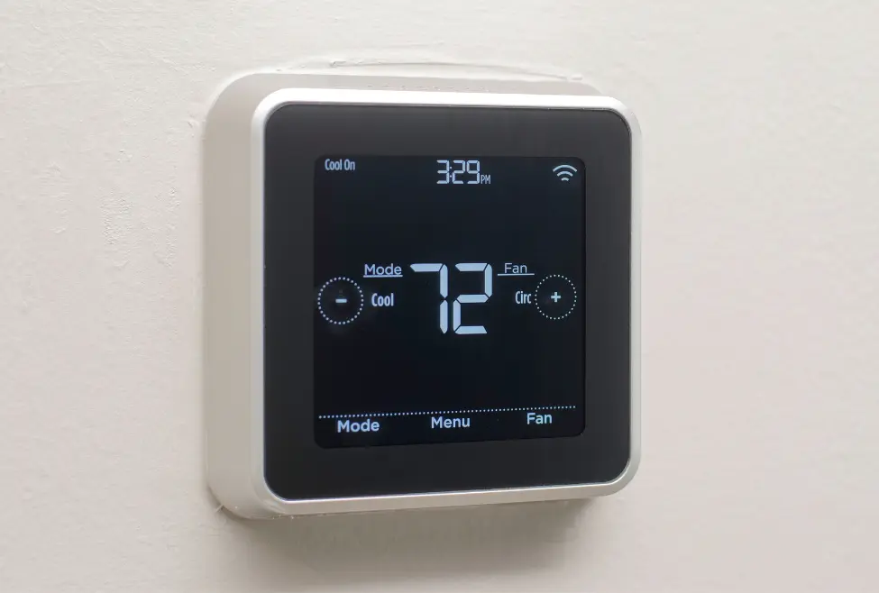Smart thermostat close-up on white wall displaying “cool on,” indicating delay mode or cooling issue—common HVAC problem related to thermostat flashing cool on, air conditioning not turning on, and AC repair services from Lochard HVAC, Plumbing, and Service. Contact us now for help with thermostat flashing cool on, thermostat says cool on but AC not running, thermostat in delay mode, why is my thermostat blinking cool on, thermostat flashing cool on fix, HVAC troubleshooting thermostat cool on, air conditioner not turning on, AC repair near me, HVAC technician near me, smart thermostat not cooling, thermostat problems AC, thermostat blinking cool meaning, AC not working thermostat says cool, HVAC repair services, HVAC maintenance near me, thermostat reset service, home cooling issues, HVAC system inspection, thermostat installation, air conditioning services near me, Lochard HVAC services, AC tune-up near me, HVAC diagnostics, thermostat delay mode fix.