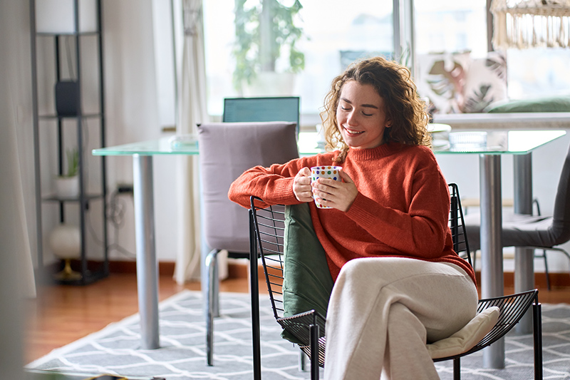woman drinking coffee while sitting in a home