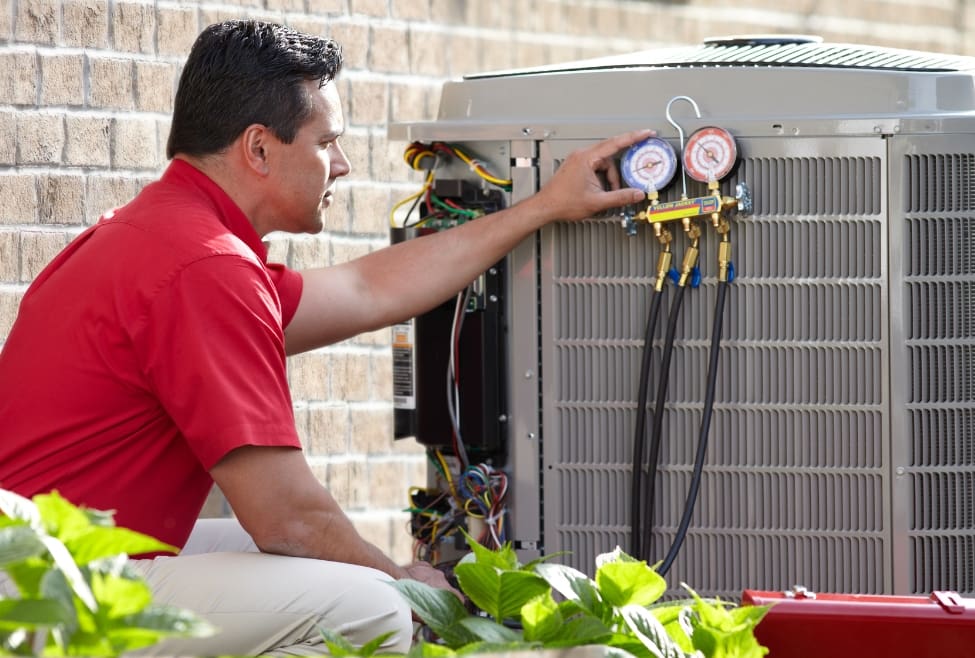HVAC technician checking refrigerant levels on an AC unit, diagnosing signs of a bad evaporator coil, including poor cooling, refrigerant leaks, and frozen coils—Lochard HVAC, Plumbing, and Service provides expert air conditioner repair, evaporator coil replacement, and AC maintenance services. Call today for help with how do I tell if my evaporator coil is bad, signs of a bad evaporator coil, how to diagnose a bad evaporator coil, evaporator coil leaking symptoms, frozen evaporator coil, weak airflow from vents, AC blowing warm air, bad AC coil repair, HVAC coil inspection, refrigerant leak in evaporator coil, evaporator coil replacement cost, air conditioner coil issues, AC not cooling properly, AC refrigerant problems, central air coil replacement, air conditioning repair near me, evaporator coil repair near me, HVAC technician near me, AC maintenance near me, Lochard HVAC services, air conditioner troubleshooting near me, AC repair Piqua, AC repair Troy, AC repair Sidney, HVAC contractor near me, HVAC diagnostics near me, HVAC repair near me.
