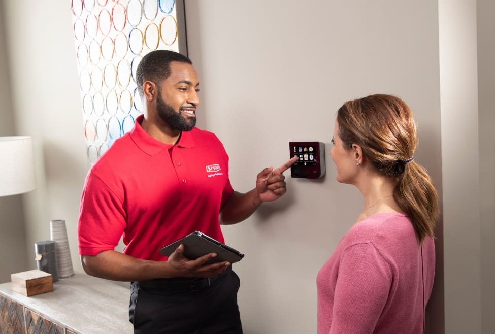 HVAC technician next to a thermostat showing ideal AC settings for summer comfort, energy savings, and cooling efficiency. Learn what temperature to set air conditioner in summer with expert HVAC tips from Lochard HVAC, Plumbing, and Service, specializing in AC installation, AC repair, and air conditioning maintenance. Contact us today for help with what temperature to set air conditioner in summer, best AC temperature for summer, recommended thermostat settings for summer, energy efficient AC settings, ideal home temperature in hot weather, AC cooling tips for summer comfort, thermostat settings to save energy, air conditioner running constantly in summer, AC not cooling properly, air conditioning efficiency tips, best thermostat temperature for sleeping in summer, how to lower energy bills with AC, AC installation near me, air conditioning repair near me, HVAC maintenance services near me, thermostat installation near me, cooling system tune up near me, central air installation near me, AC replacement services, air conditioner troubleshooting in hot weather, professional HVAC services near me, Lochard HVAC AC repair services, plumbing and HVAC experts near me.