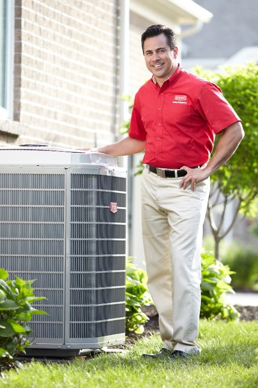 Lochard Inc, Lochard HVAC Plumbing and Service, AC Installation Near Me, AC Installation Sidney OH, AC Replacement Near Me, AC Replacement Sidney OH Lochard HVAC, Plumbing & Service technician smiling beside an outdoor air conditioning unit, representing AC installation and replacement in Sidney, OH including new AC system installation, central air replacement, energy-efficient HVAC upgrades, air conditioner sizing and setup, refrigerant charging, compressor testing, thermostat installation, and residential cooling system installation services.